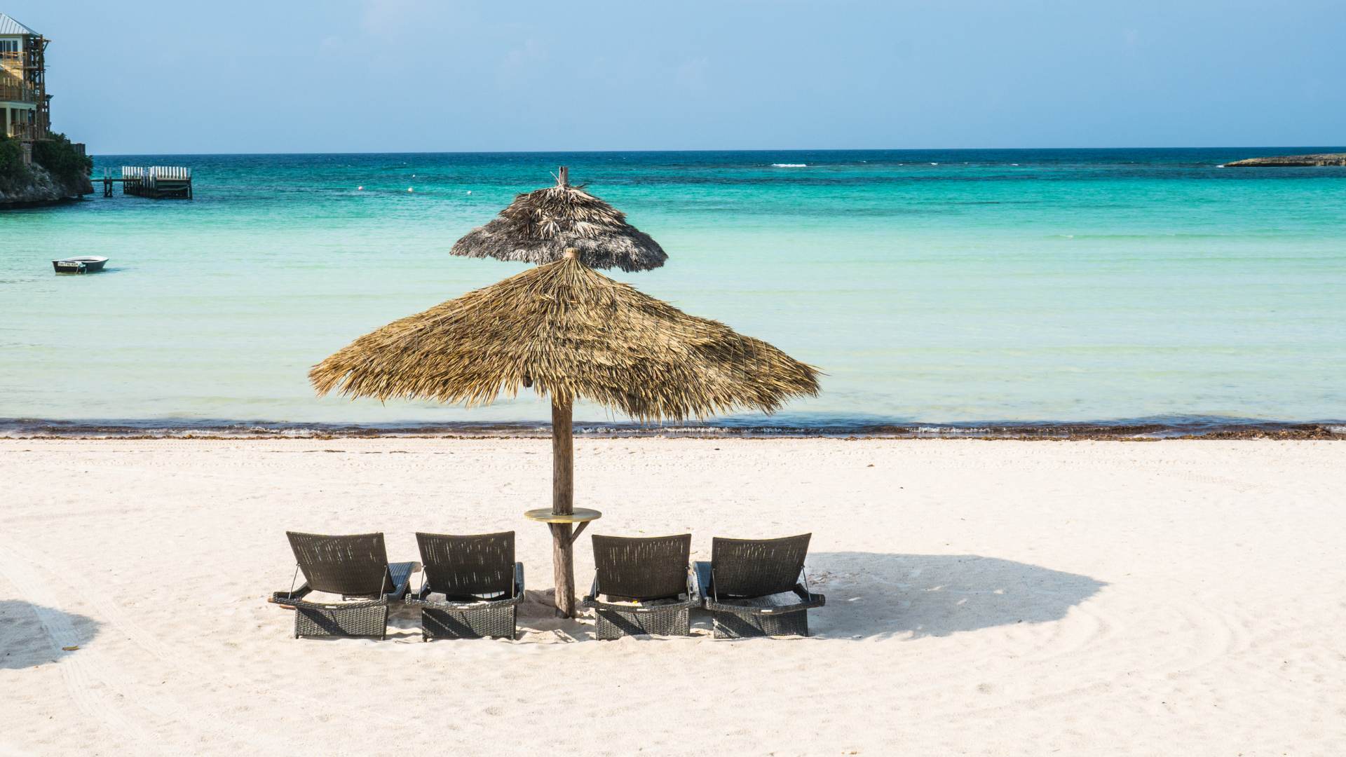 Thatched umbrella and loungers on the white sand at Tahiti Beach, Elbow Cay