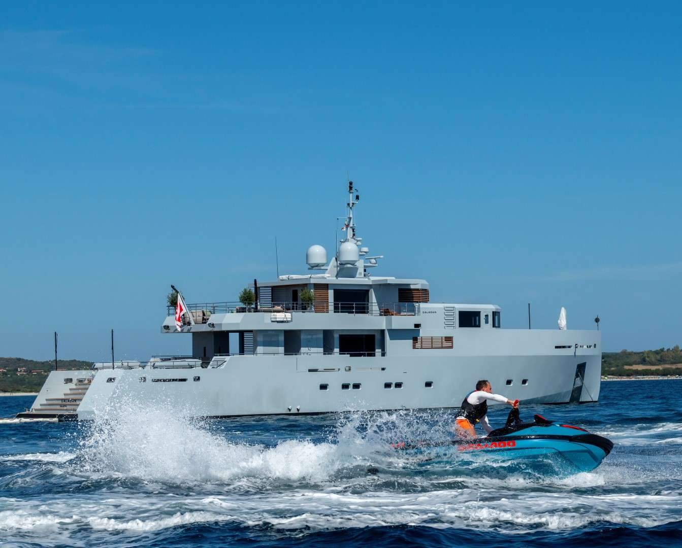Capri at anchor — water toys deployed, the boat the centerpiece of the day, the cliffs and the cruise crowd irrelevant.