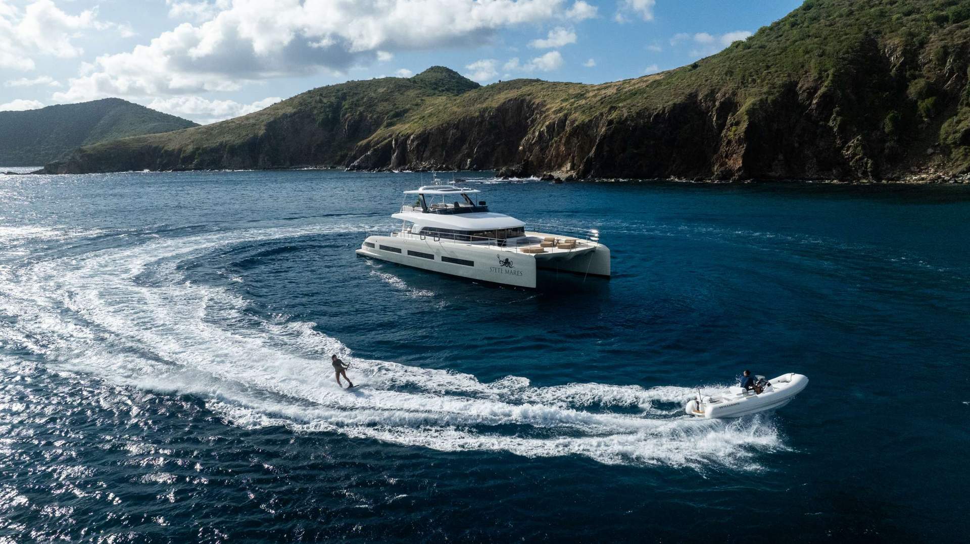 Family swimming off the transom of a crewed catamaran.