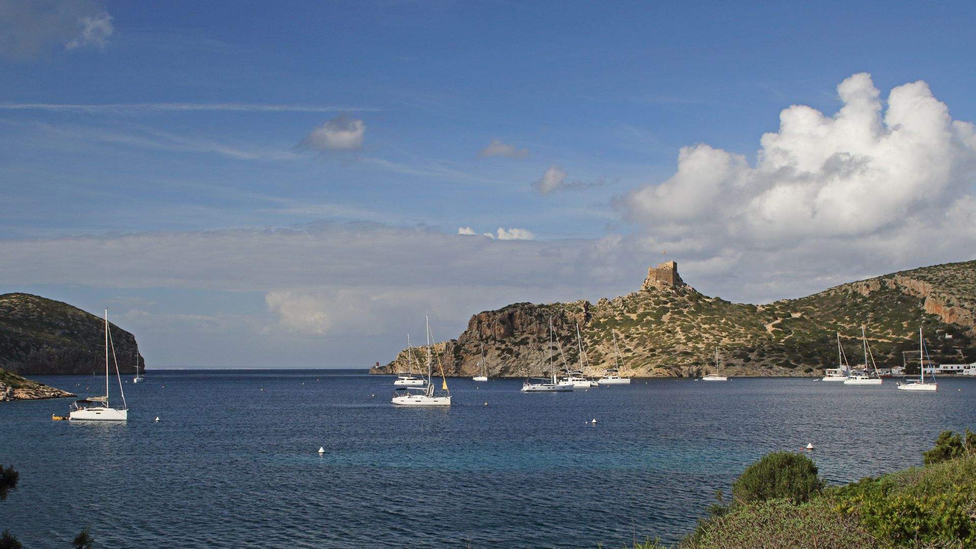 Cabrera National Park's permit anchorage at evening with the castle on the headland.