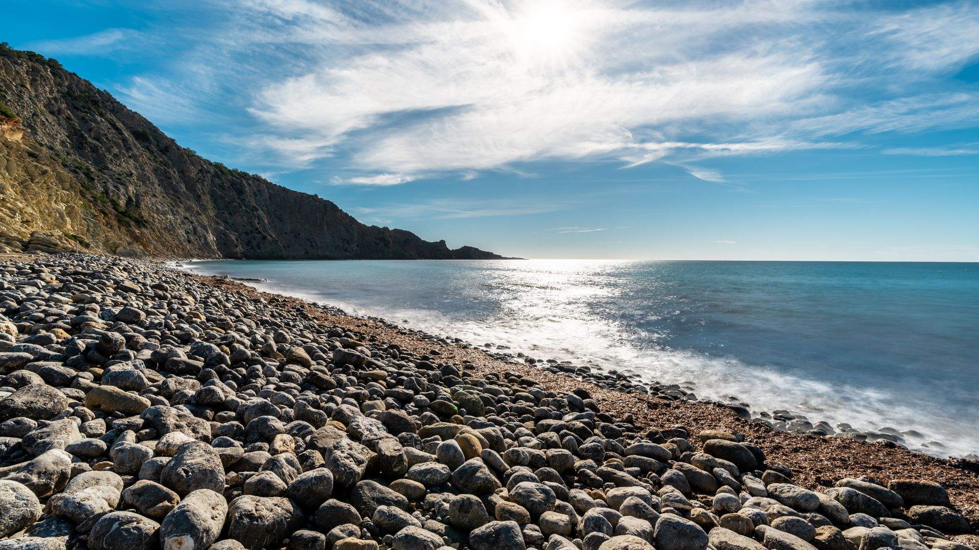 The Ibiza east-coast loop — short hops between coves, tendered runs to beach bars, swim afternoons between.