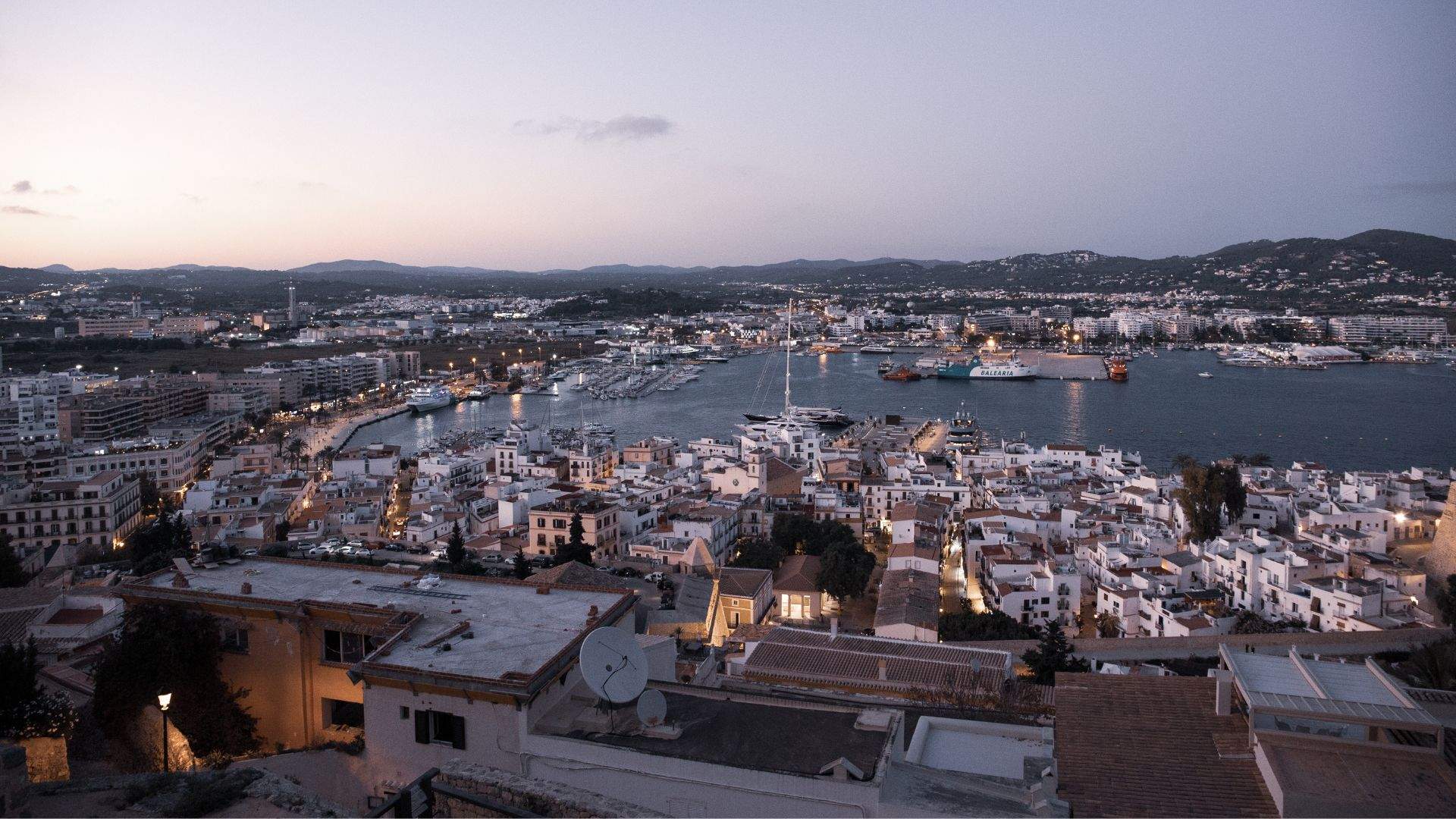 Ibiza Town arrival from the water — Ibiza's old walled town rising above the marina.