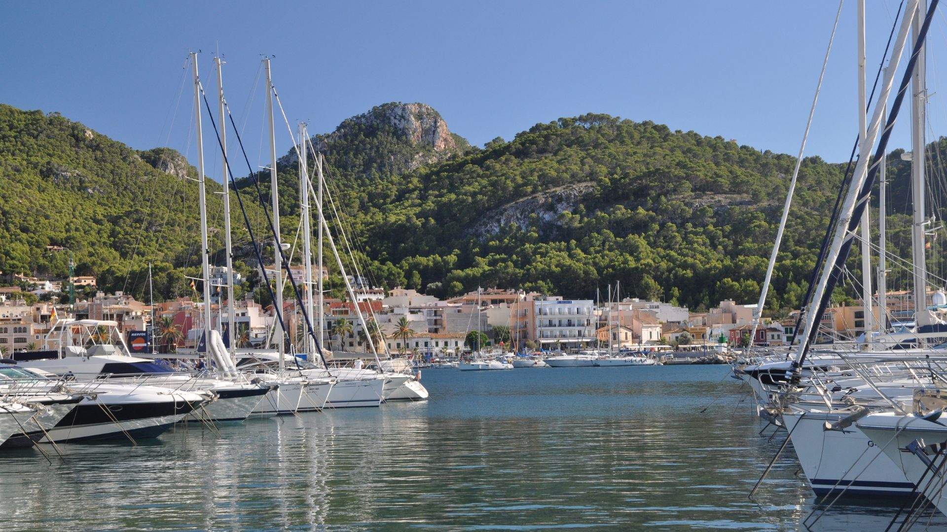 Port d'Andratx fishing harbor at evening with crewed yachts at the quay — Mallorca SW coast