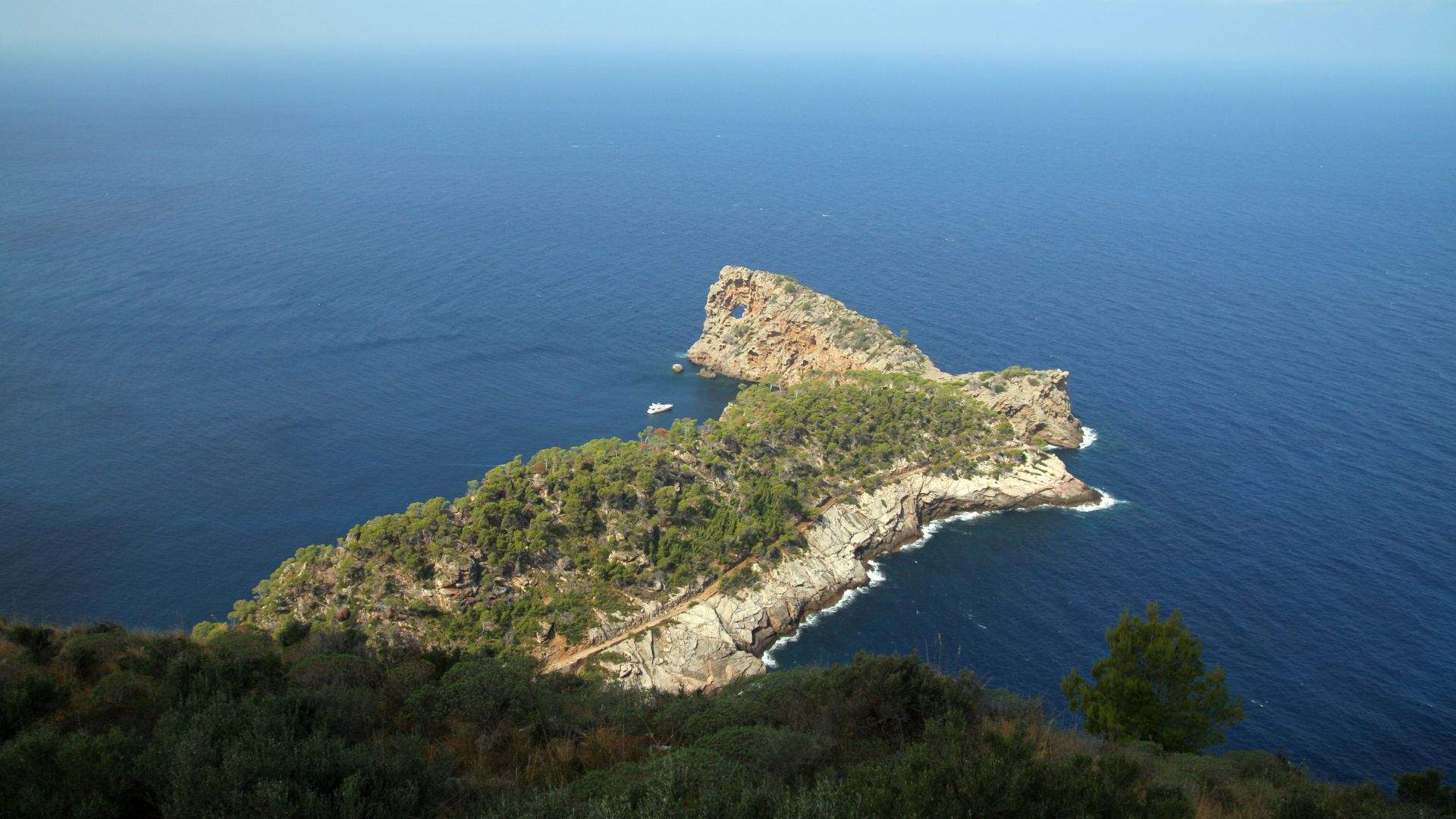 Tender approaching the Sa Foradada rock peninsula on Mallorca's Tramuntana coast