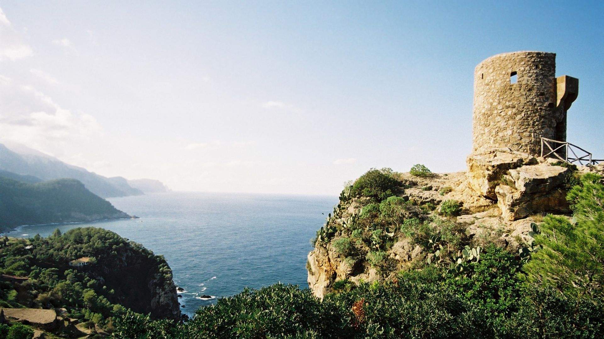 Mallorca's mountain coast from below — granite and limestone falling straight to the water along the island's northwest face.