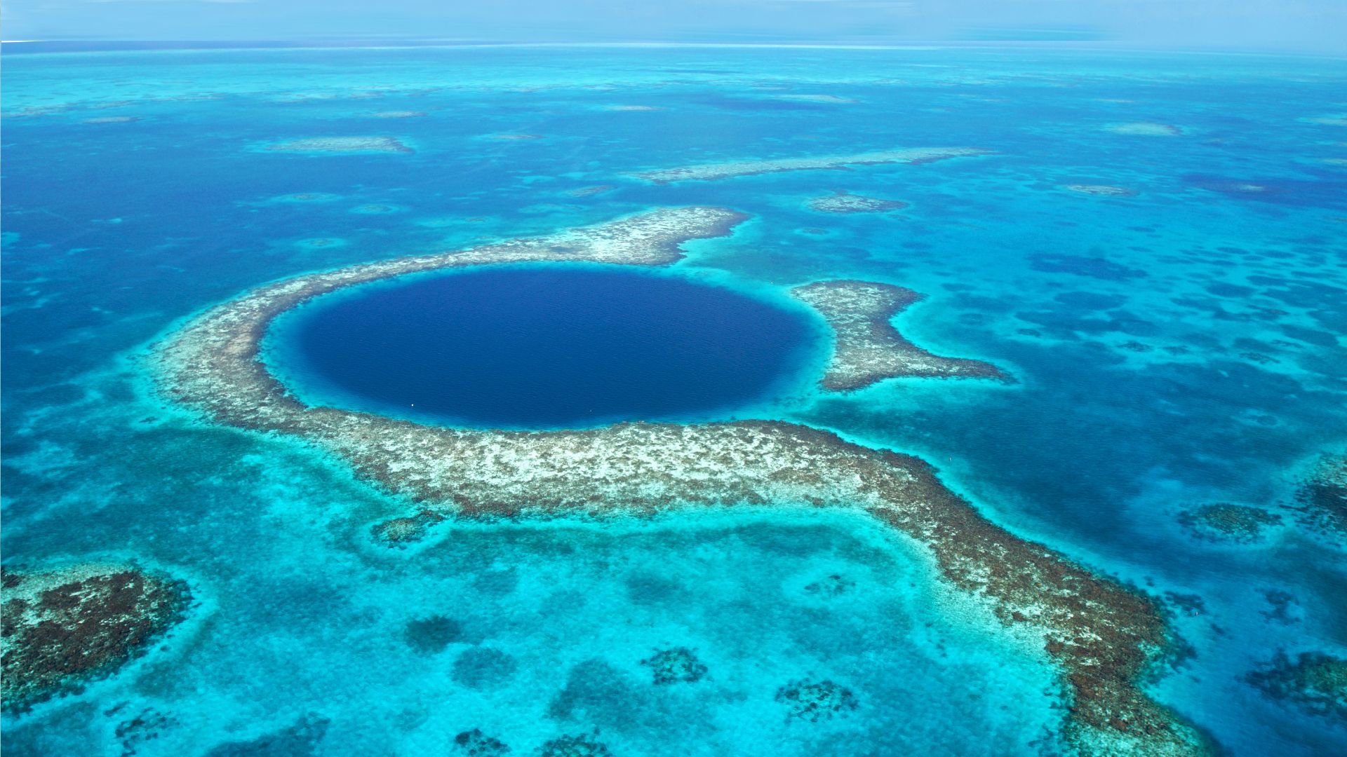 The Great Blue Hole from the air—a circular sinkhole in the center of Lighthouse Reef.