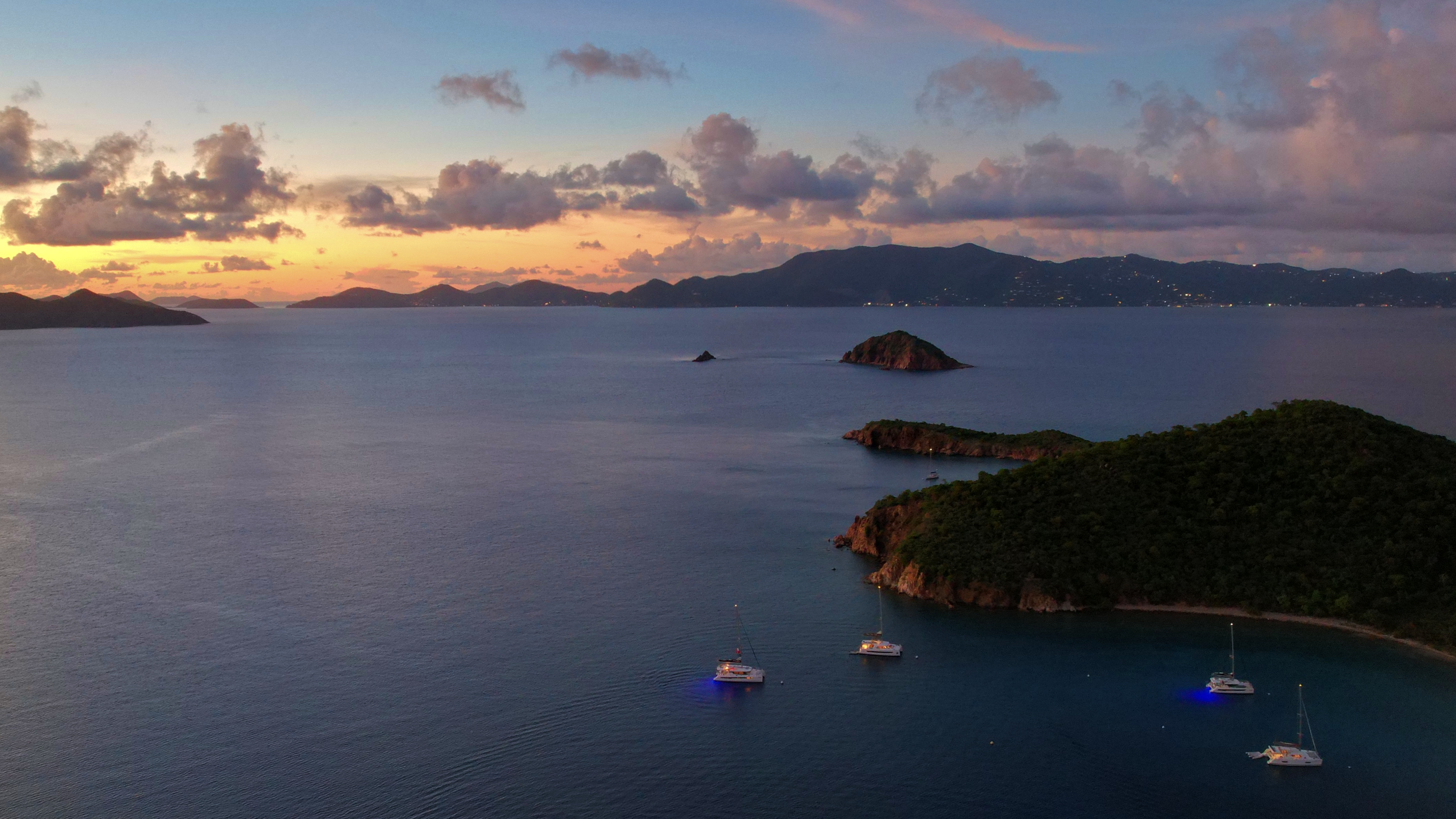 Enjoy a spectacular sunset view amidst the rocky shores of Norman Island.