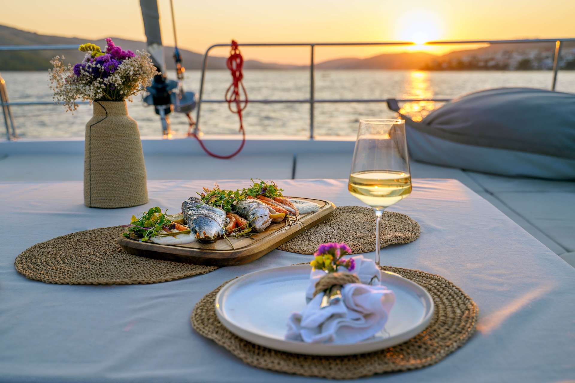 Sunset dinner on a crewed Croatia yacht — grilled fish, white wine