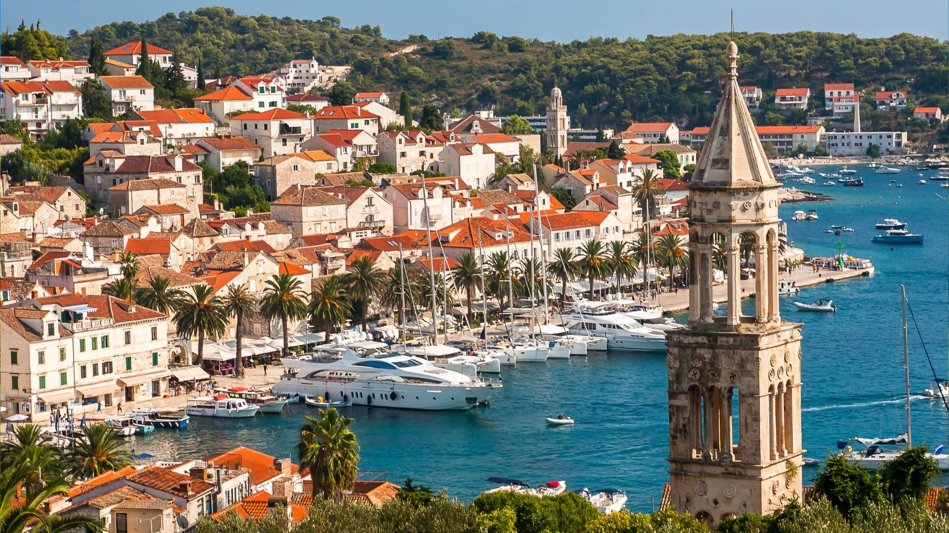 Hvar Town harbor with the Spanish Fortress rising above the rooftops.