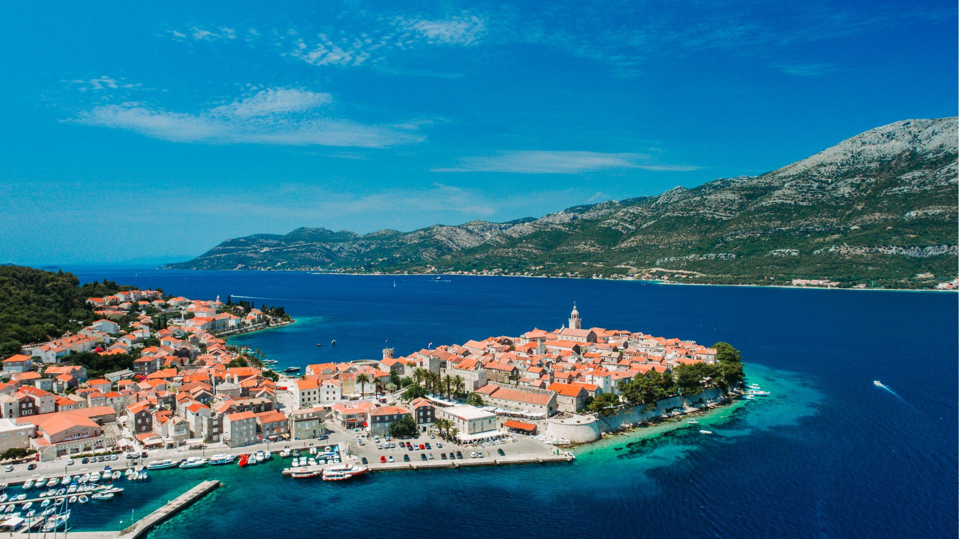 The walled old town of Korčula on its small peninsula—terracotta rooftops inside medieval fortifications.
