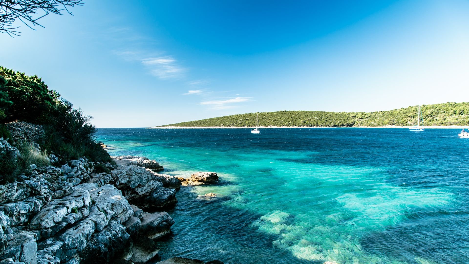 A summer day on the Dalmatian coast with boats at anchor.