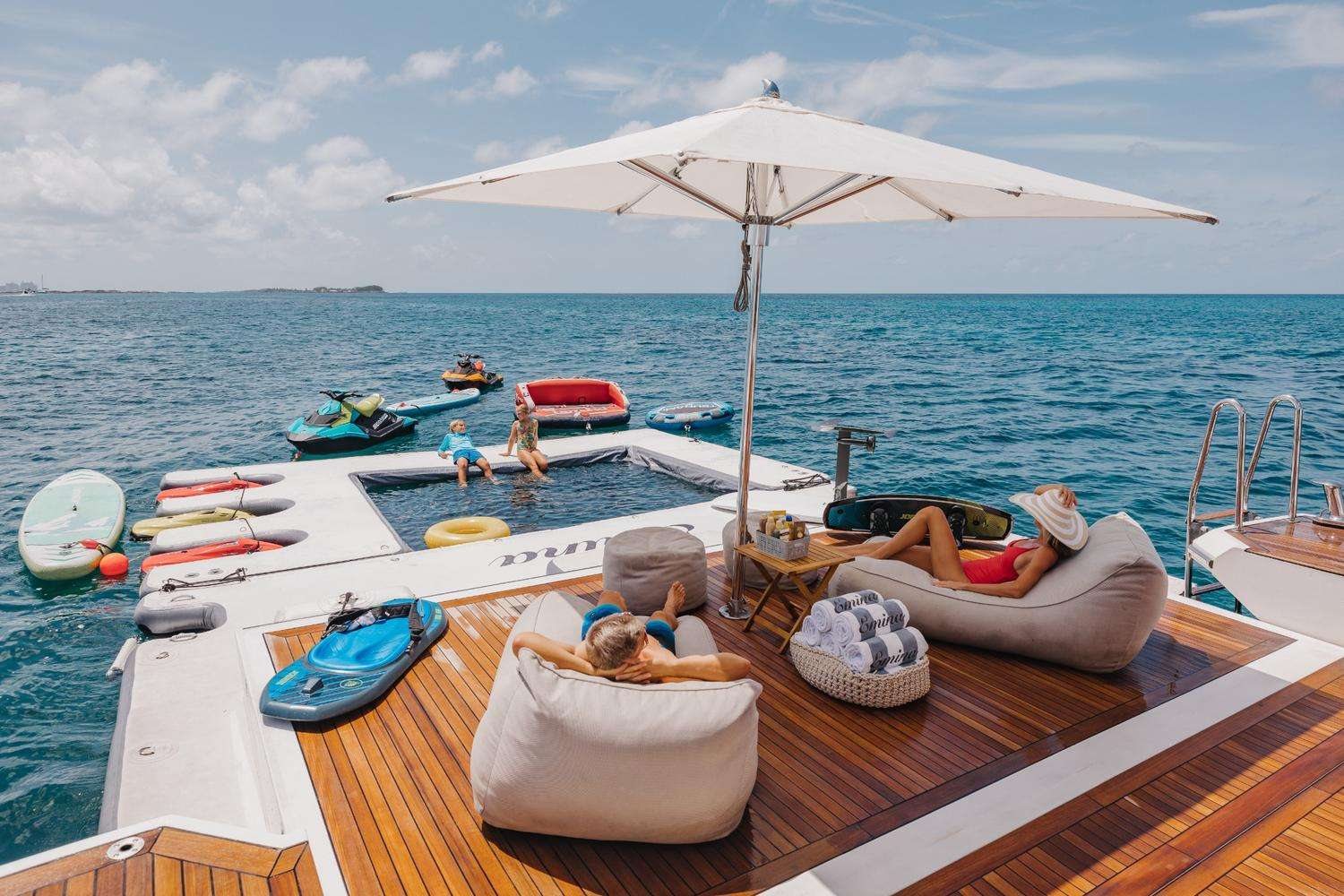 The afternoon on the water — jet skis, seabobs, paddleboards, and the floating dock off the swim platform.