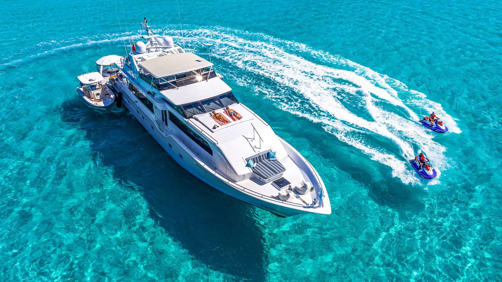 The rest of the afternoon is on the water — the jet skis and toys off the yacht.