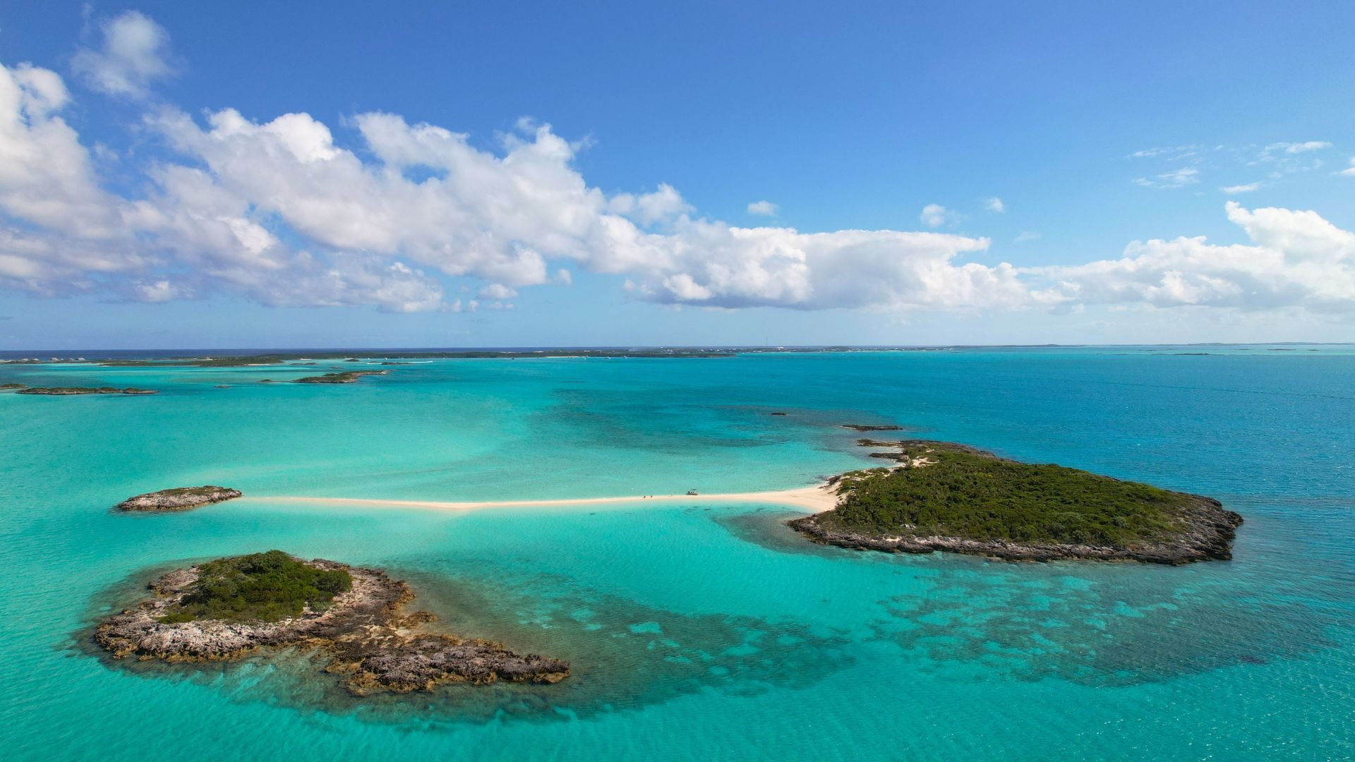 Sandbars and cays surface across the central Exumas at low water — private, shifting, and impossibly clear.