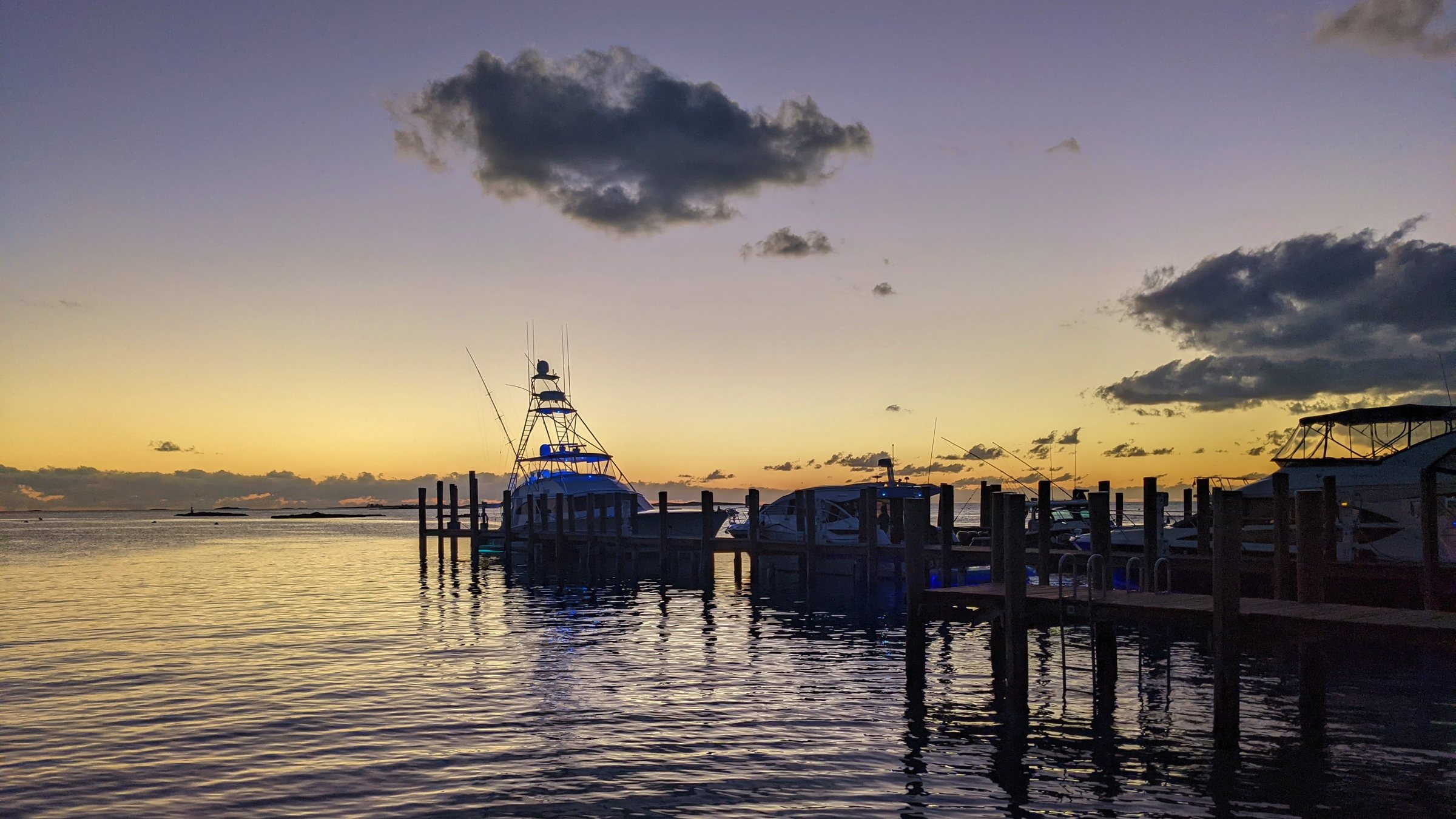 Sunset over the Staniel Cay dock — a drink ashore at the Yacht Club before the tender back to dinner.