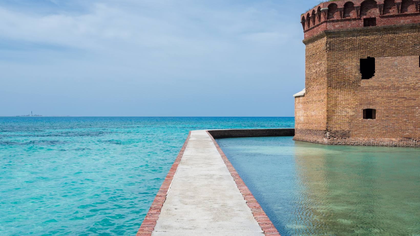 Fort Jefferson's moat walk running between turquoise sea and the brick fortress wall