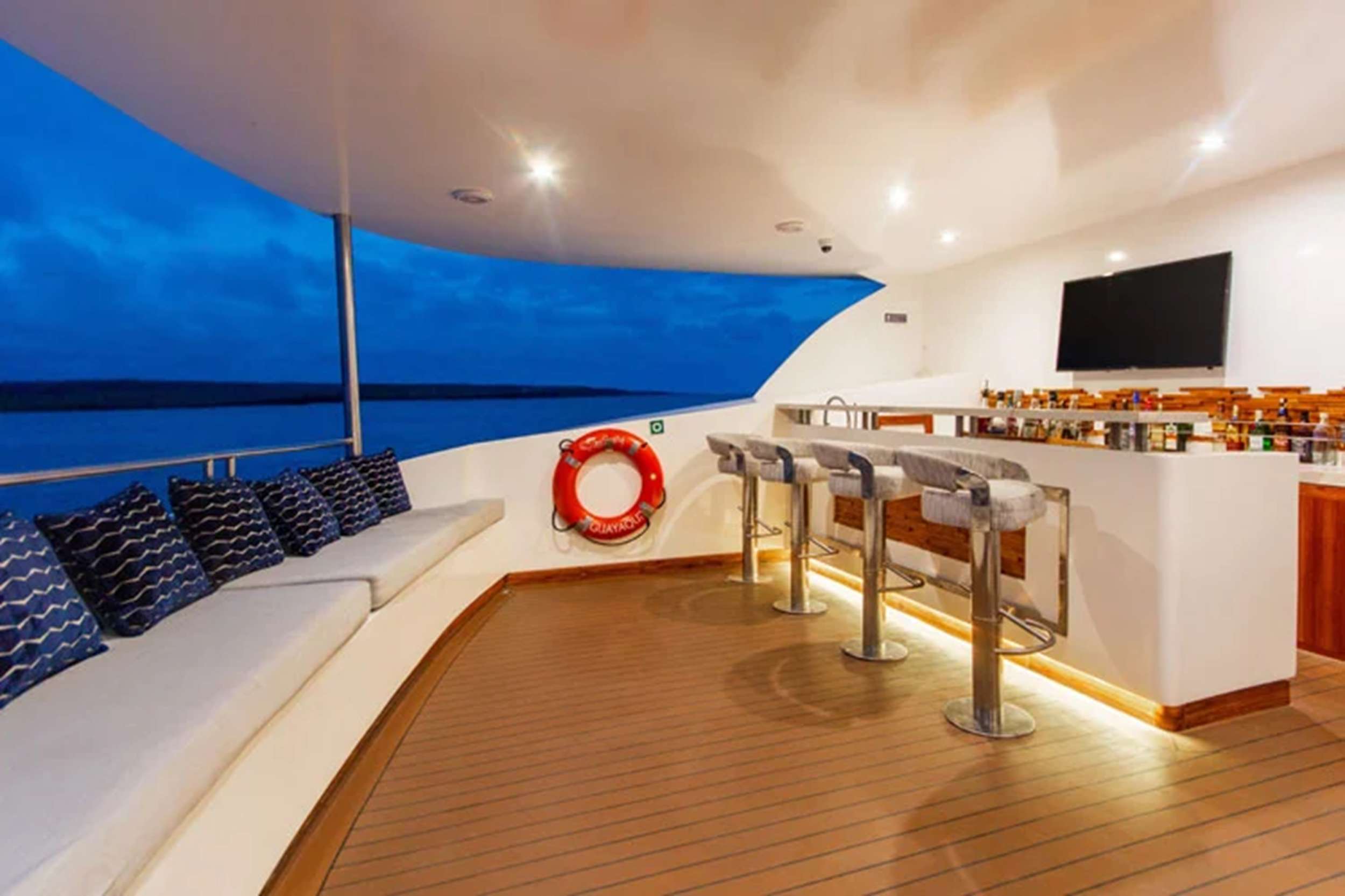 Aft lounge of an expedition yacht at blue hour