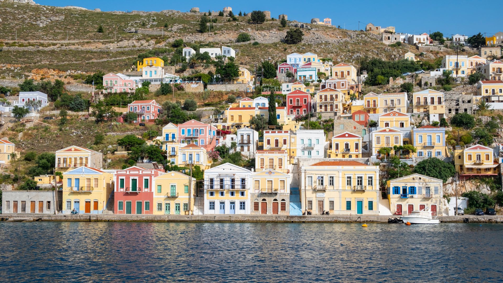Yialos harbor, Symi — pastel neoclassical houses in the Dodecanese