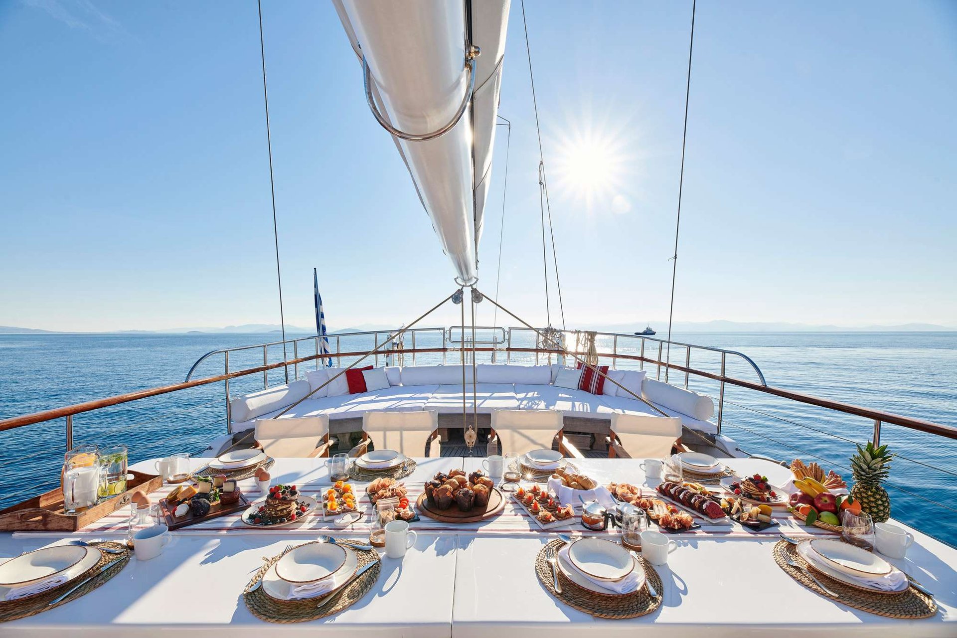 Breakfast laid on the bow of a crewed yacht in Greece