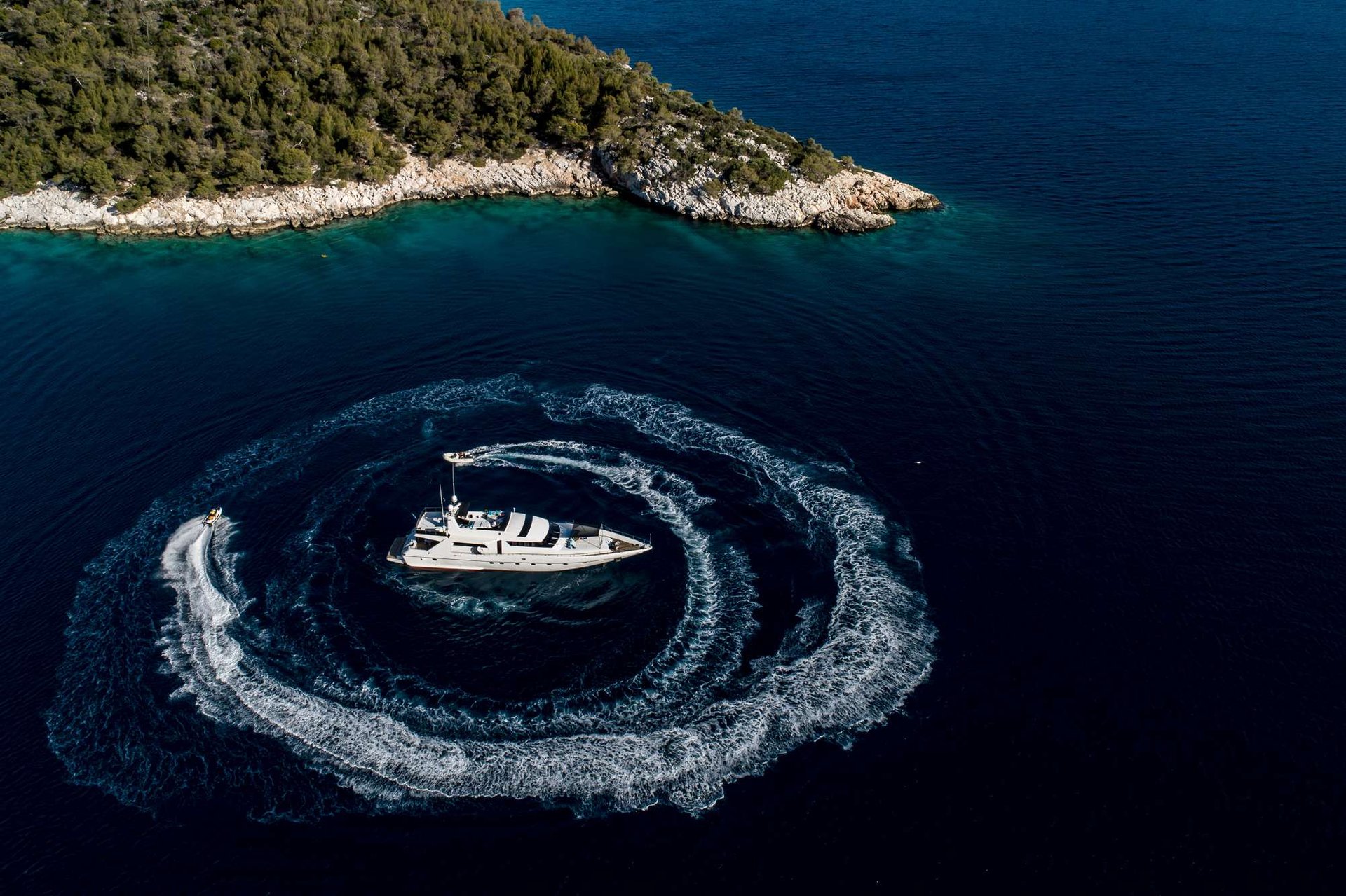 Aerial of a crewed catamaran underway in the Aegean