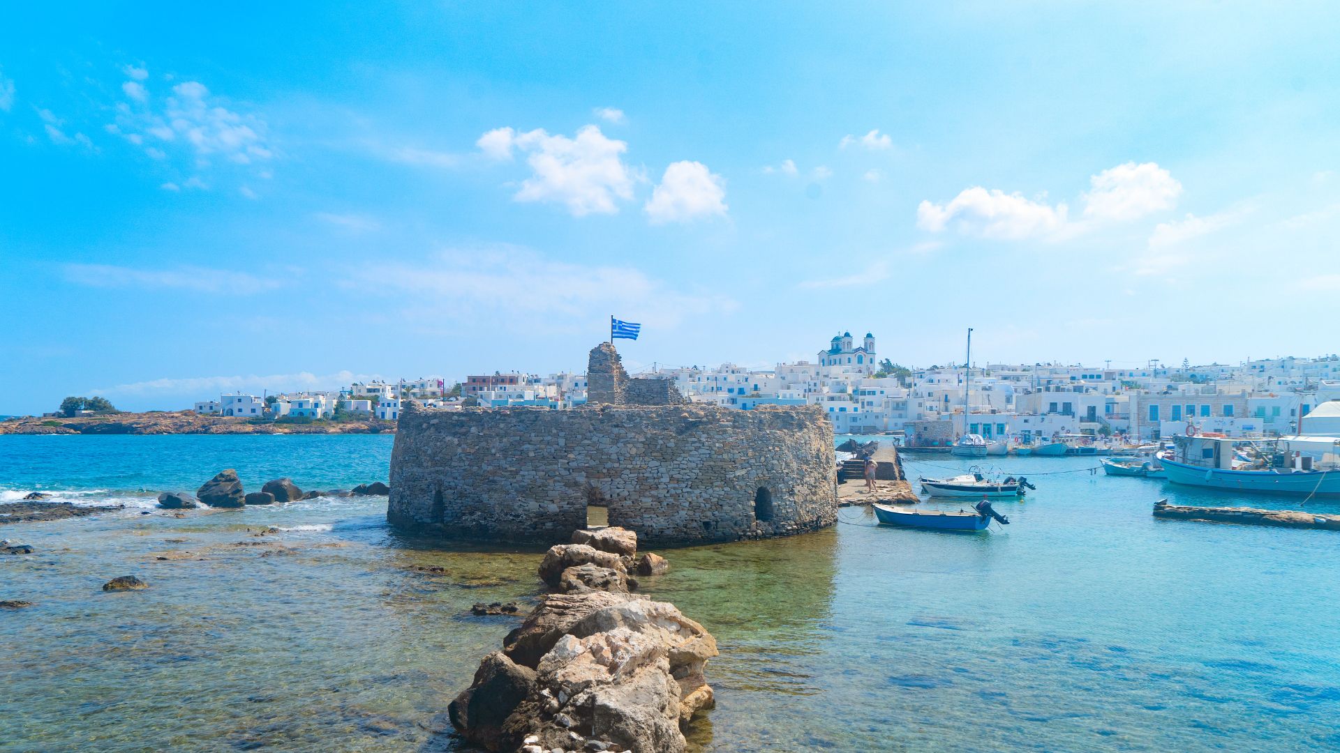The fishing harbor at Naoussa, Paros, with blue-painted wooden boats.