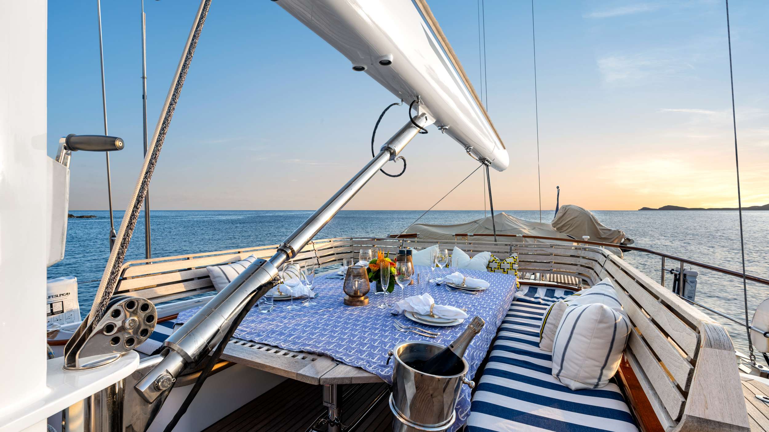 Sundowners at anchor before the tender ride to dinner ashore—the aft deck does most of the work on a crewed week.
