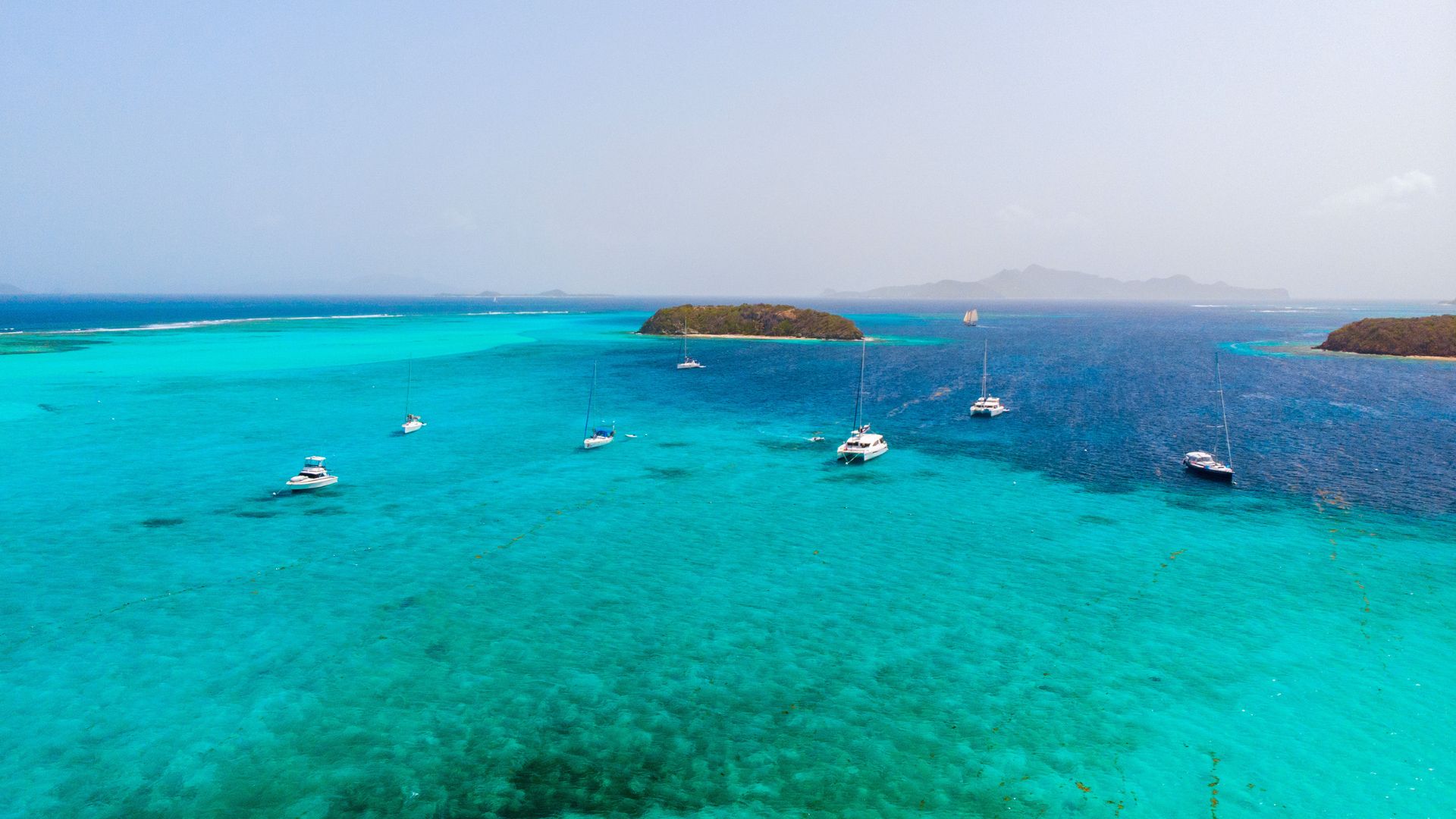 Anchored inside Horseshoe Reef—the cays in front of you, the open Atlantic crashing on the reef behind, and the rest of the day on whatever schedule you want.