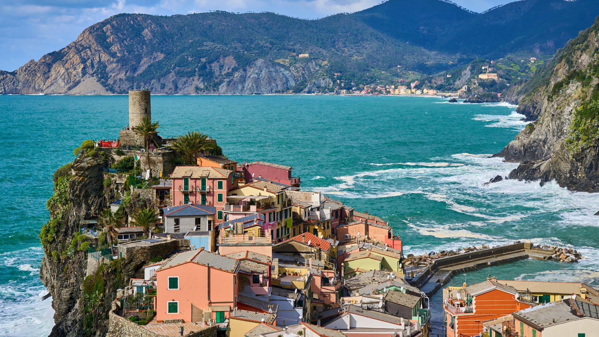 Vernazza's cliff village and Belforte tower seen from above the harbor.