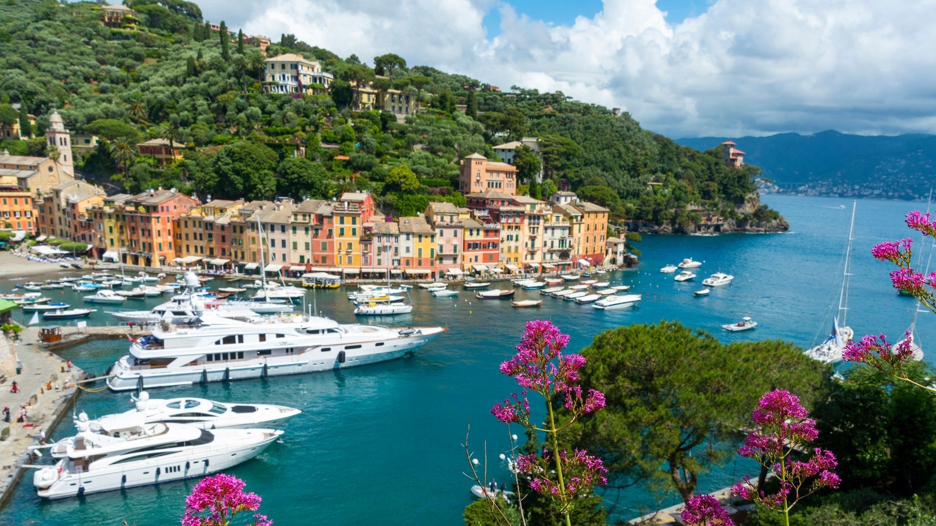 Portofino harbor and hillside villas from above — the Belmond Splendido visible above the pastel facades.