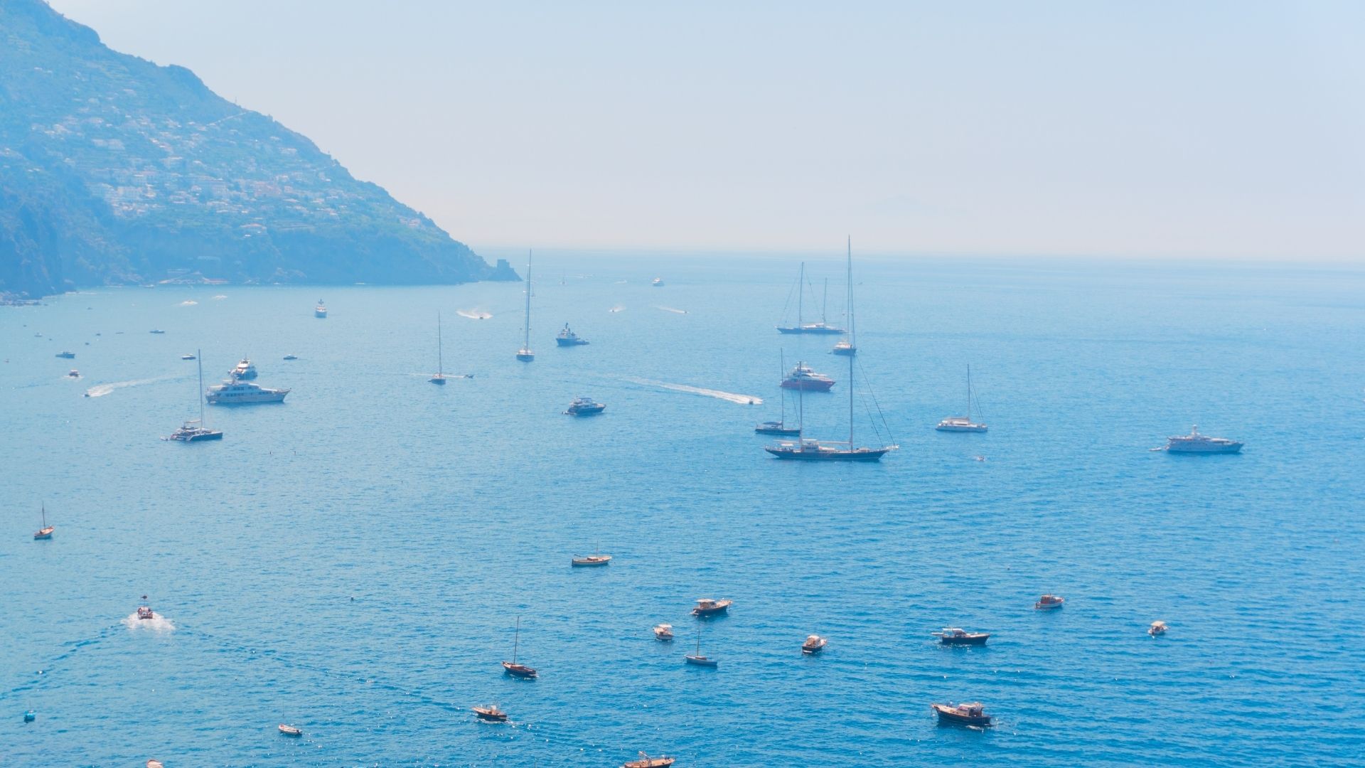Aperitivo on the aft deck — the closing rhythm of the week. The last full day stages the yacht back into the Tigullio for a final harbor night before disembarkation, rather than collapsing into an administrative return to Genoa.