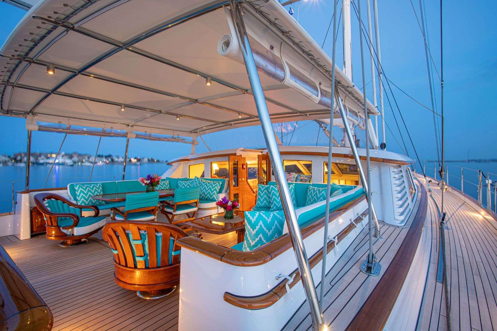 Evening under the aft-deck awning of a classic sailing yacht in a New England harbor