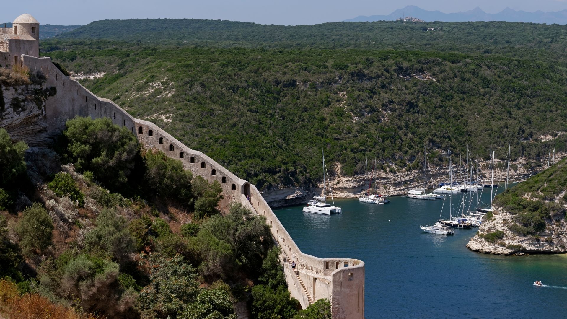 The Bonifacio approach is fjord-like — a narrow channel cut into the limestone, with the haute ville rising directly above the harbor.
