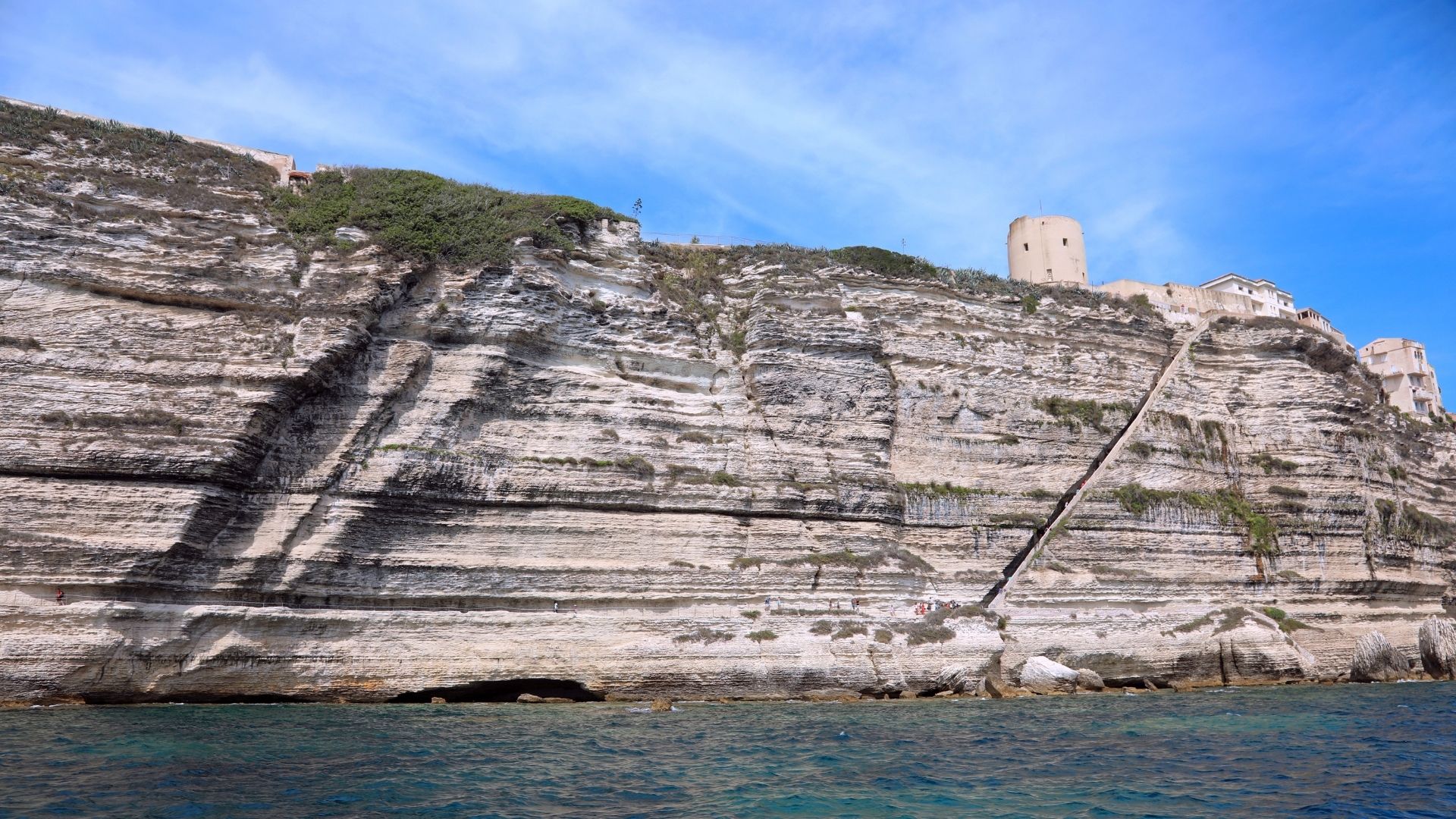 The King of Aragon Stairway — a hundred and eighty-seven steps cut into the cliff face below the haute ville, traditionally said to have been carved overnight in the fifteenth century.