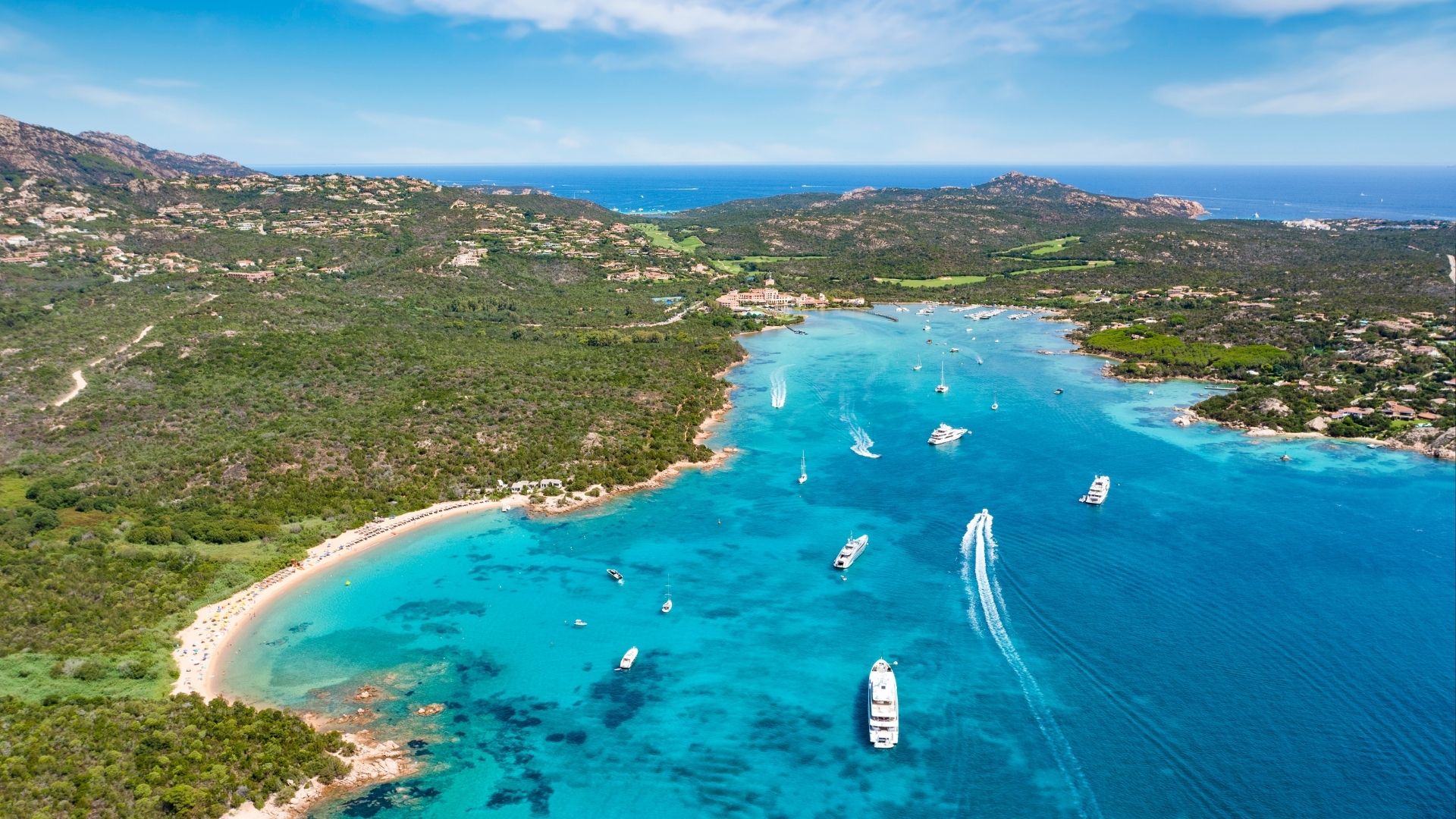 The Costa Smeralda's sheltered bays catch the late-afternoon sun, with the granite ridges holding the heat.