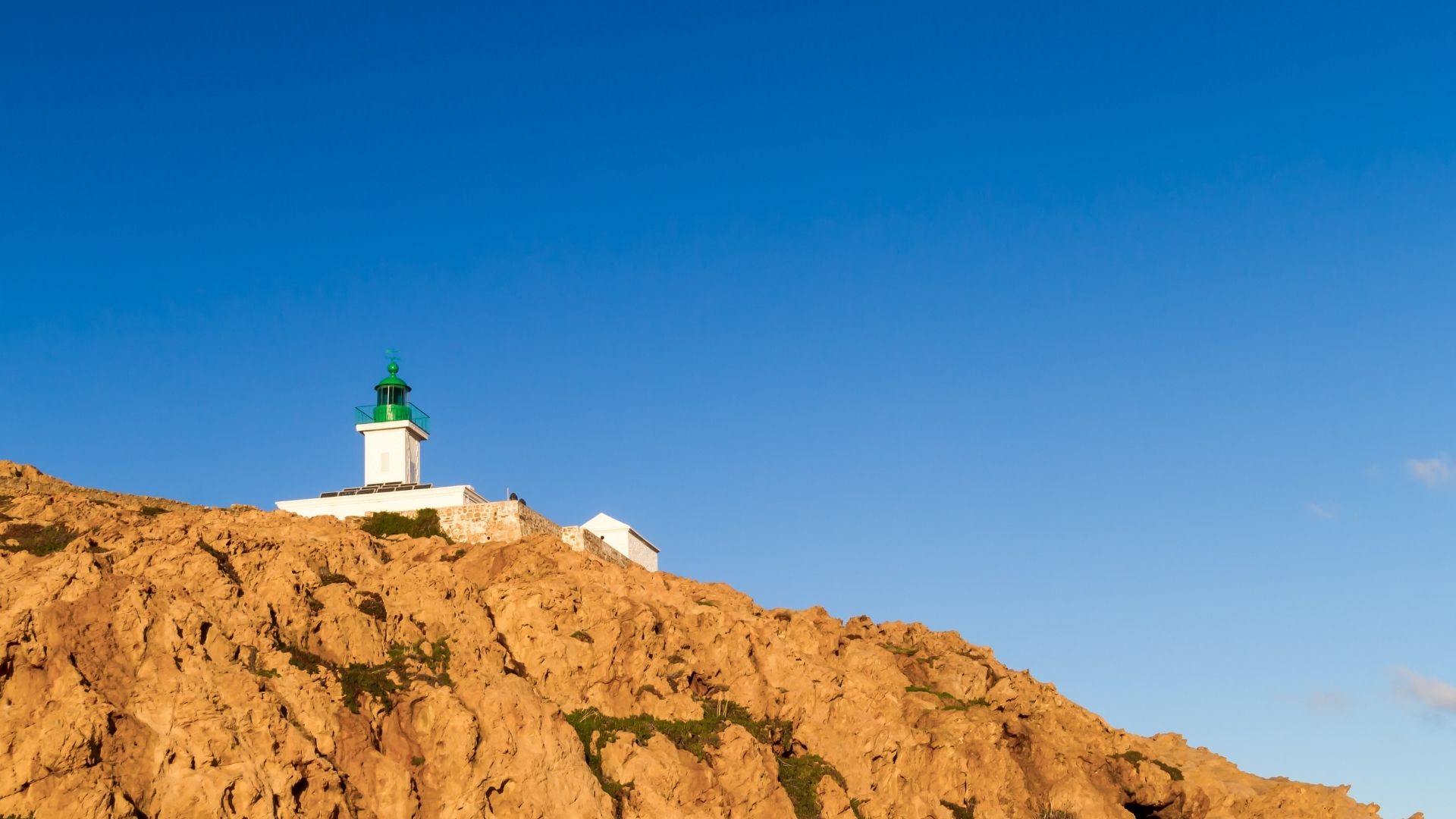 Île Rousse takes its name from the small reddish-granite islets that sit offshore. A working ferry harbor that runs the daily Marseille service, plus a small charter-friendly anchorage on the lee side.