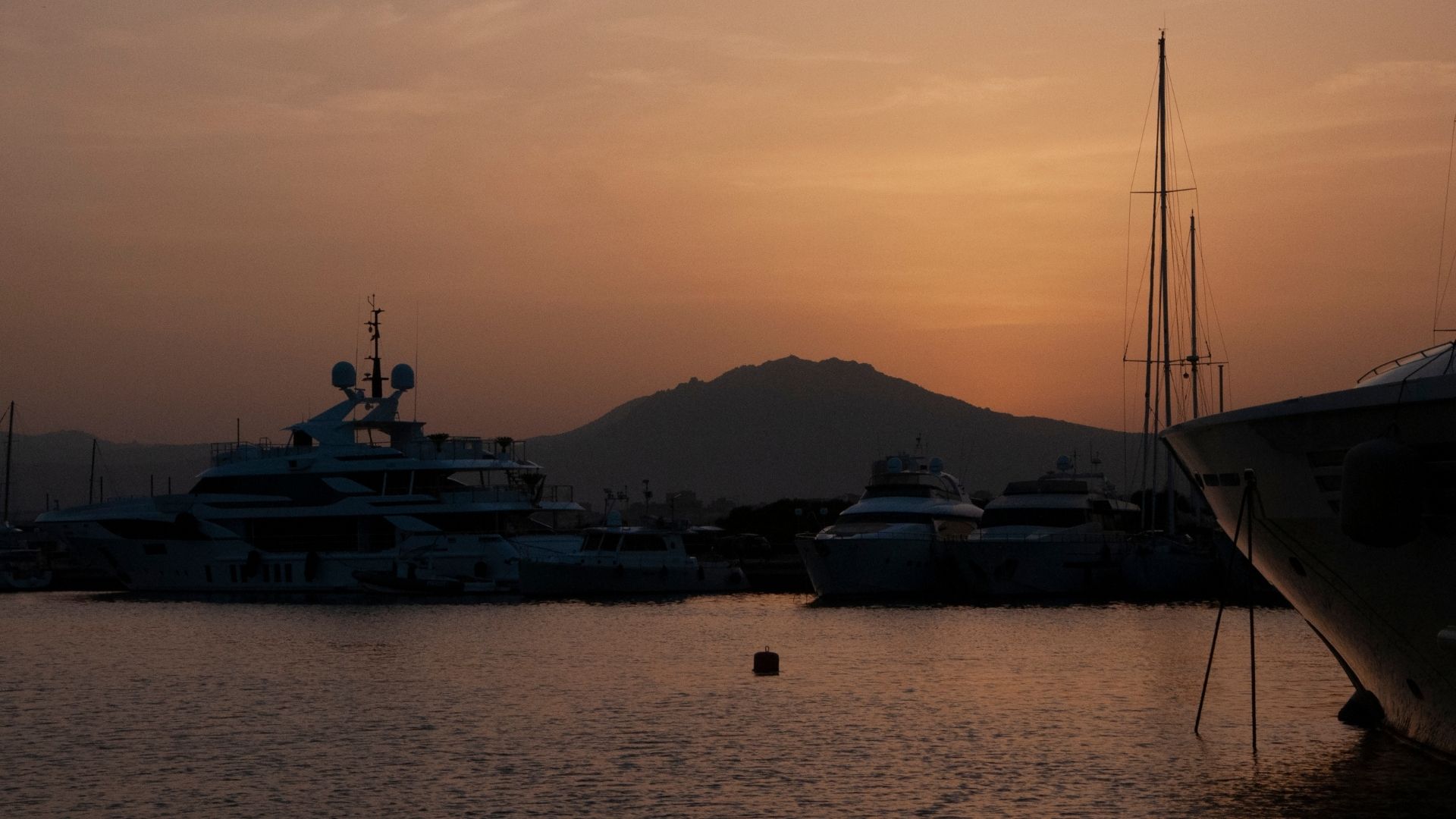 Boarding day at Marina di Olbia — a fifteen-minute taxi from OLB airport, deep-water capable, and the embarkation point for most Sardinian charters.