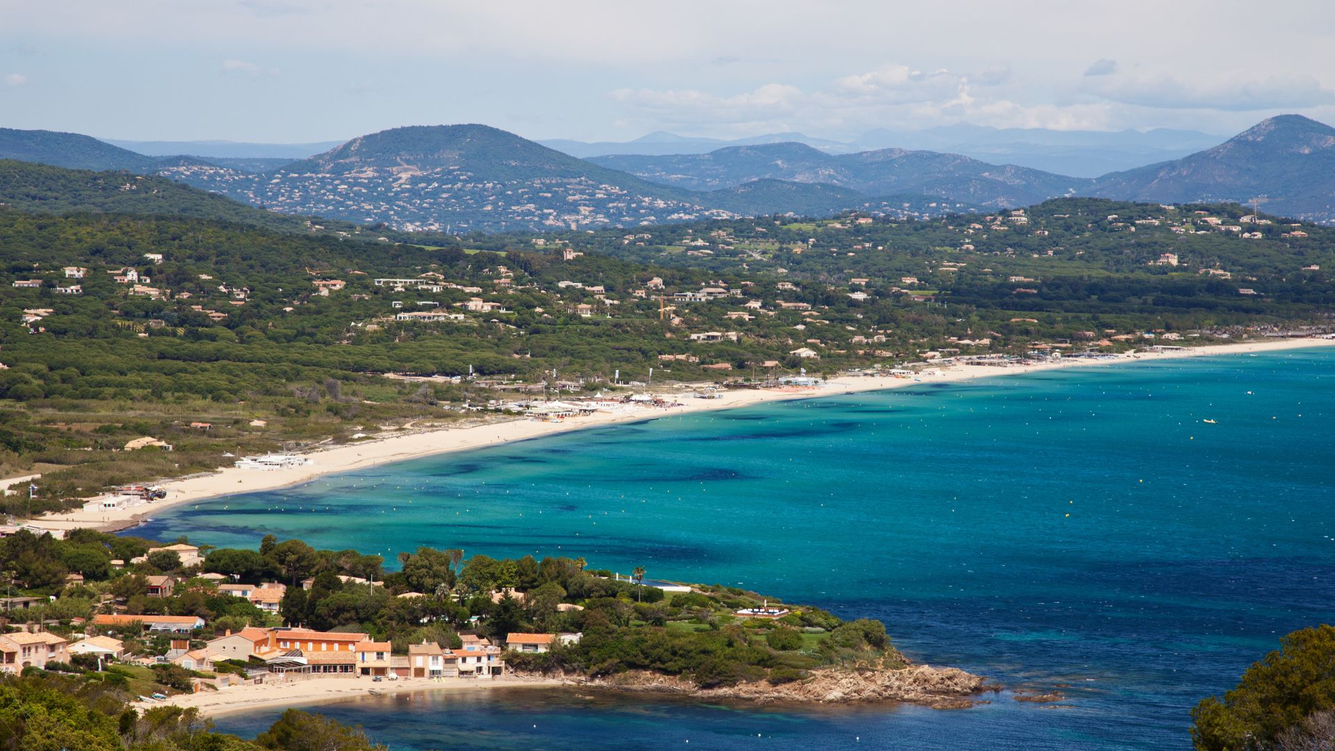 Pampelonne Beach east of Saint-Tropez — three miles of fine sand with beach clubs at Club 55, Nikki Beach, and Tahiti Plage along the dunes. Tender ride from the bay anchorage.
