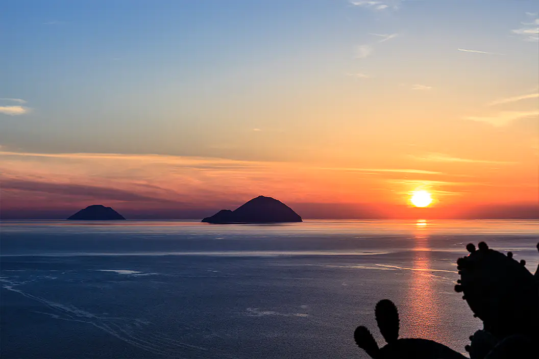 Filicudi and Alicudi at sunset — the quiet western end of the chain and the week's last anchorage before the run back to Milazzo.