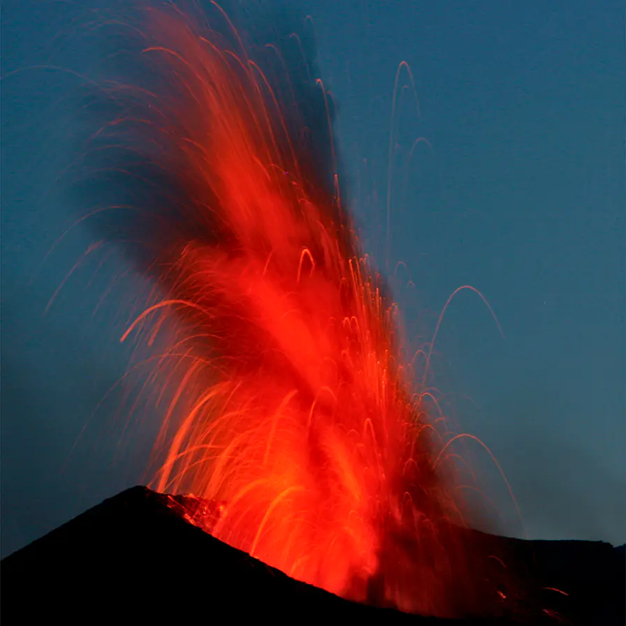 Stromboli at night — the marquee scene of the Aeolian week. The Sciara del Fuoco anchorage on the northwest shore faces the active crater; the eruption is visible from the foredeck on a fifteen-minute cycle.