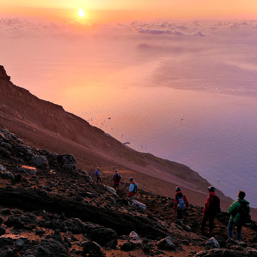 Guided sunset summit hike on Stromboli, the Tyrrhenian Sea far below — a classic Aeolian shore excursion.