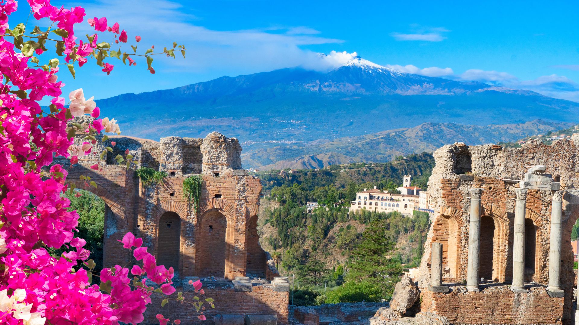 The Greek theatre at Taormina with Mount Etna in the distance
