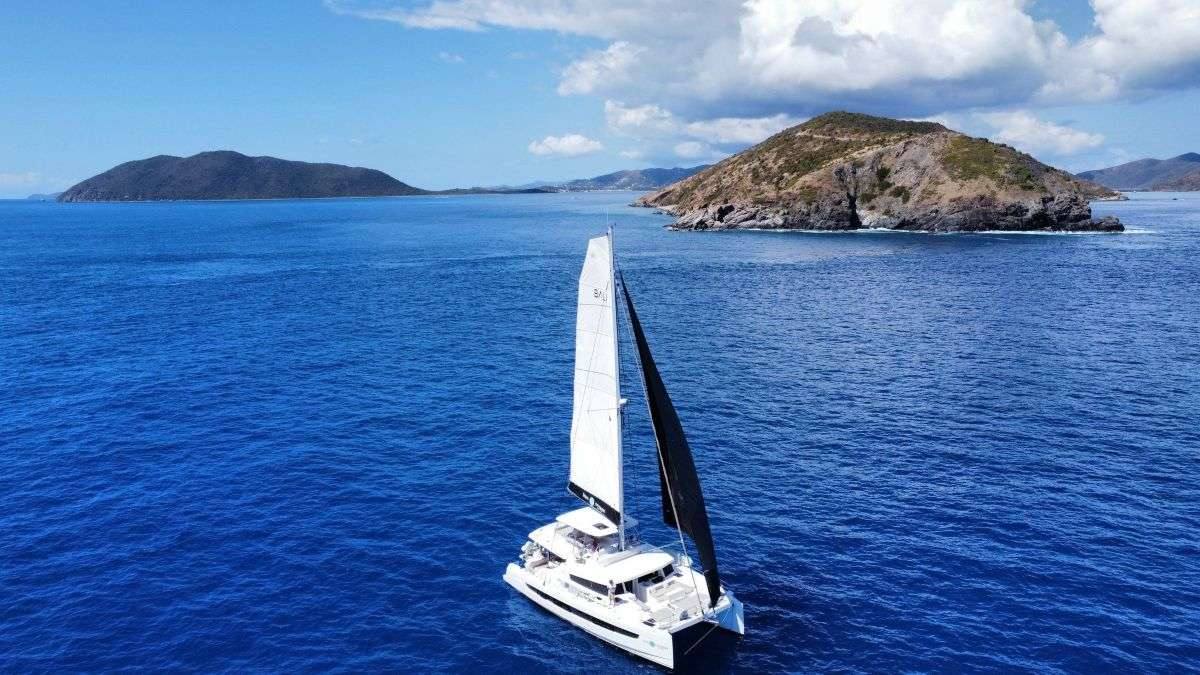 Crewed sailing catamaran under sail in open Caribbean water