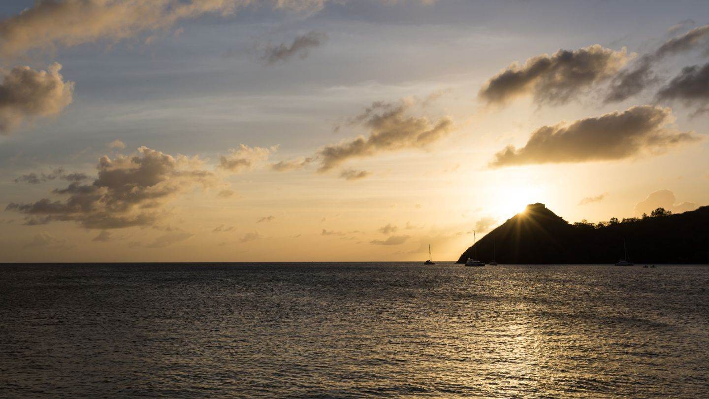 Last light behind Pigeon Point from the Rodney Bay anchorage — the week's closing frame.