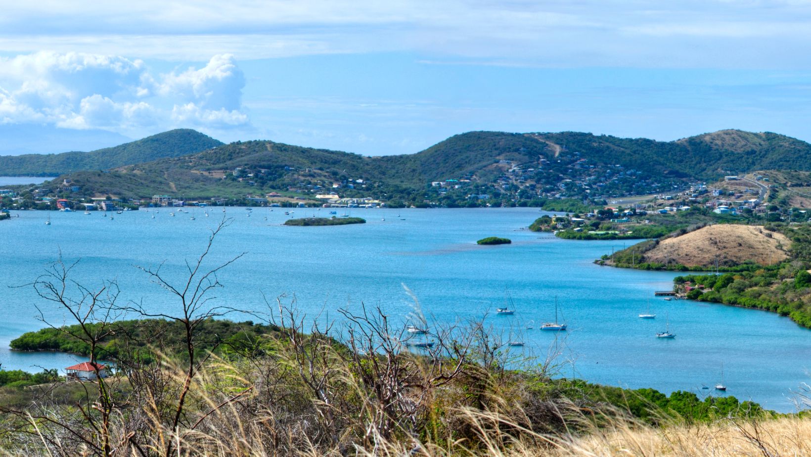 Dewey from above the hill — the only town on Culebra. Two blocks long, a hand-cranked drawbridge over the Canal de Luis Peña, and the kind of pace that makes the whole island feel like the town.