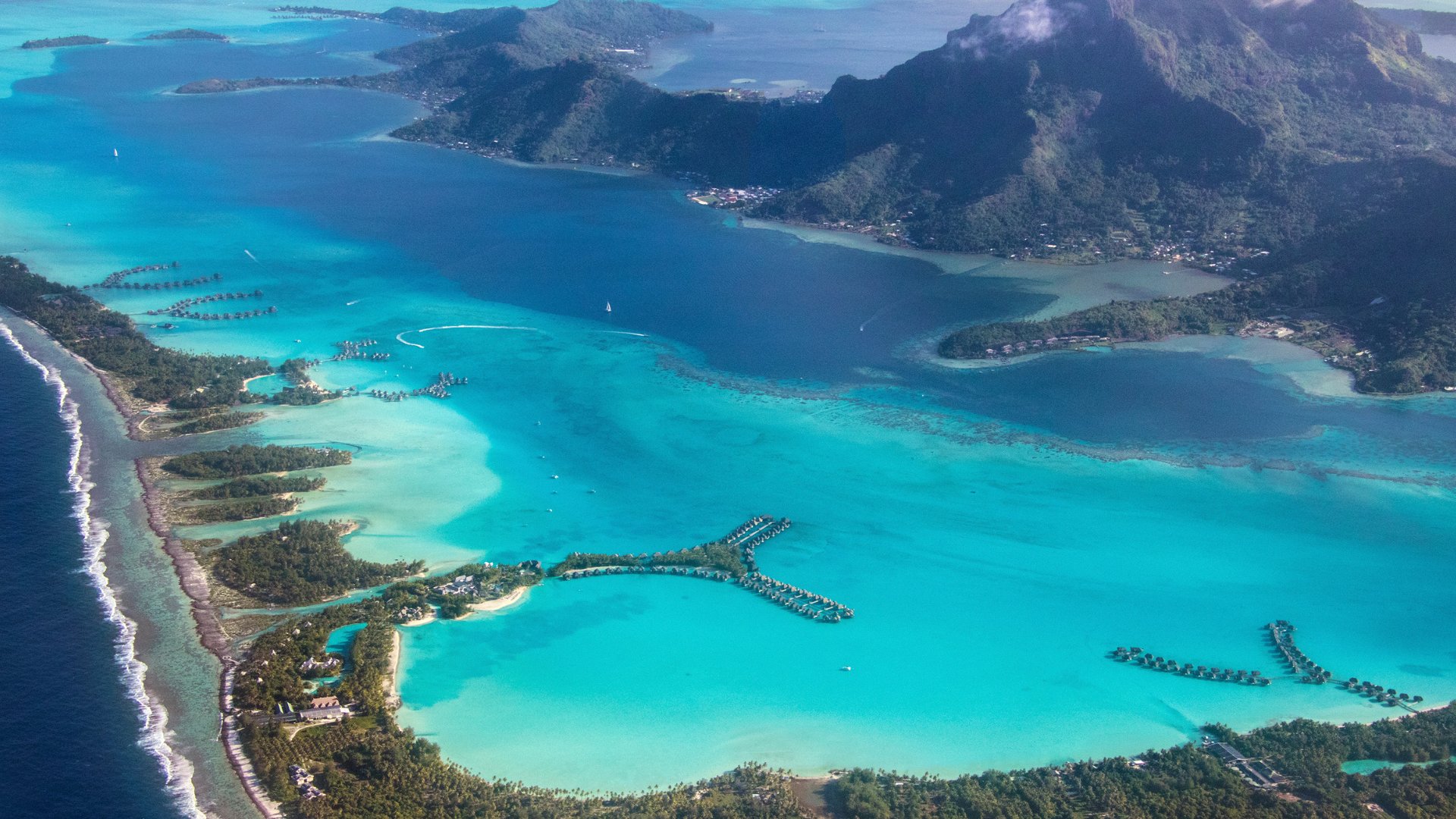 Aerial view of Bora Bora, Mount Otemanu, and the barrier reef.