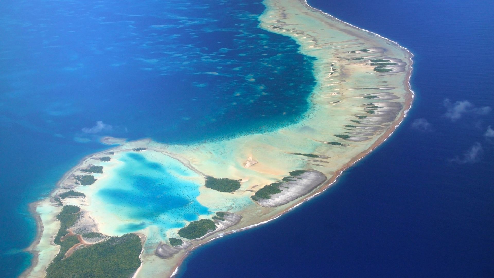 The Blue Lagoon at Rangiroa—pink-sand motu and electric turquoise shallow water inside the lagoon at Motu Tāūtū.