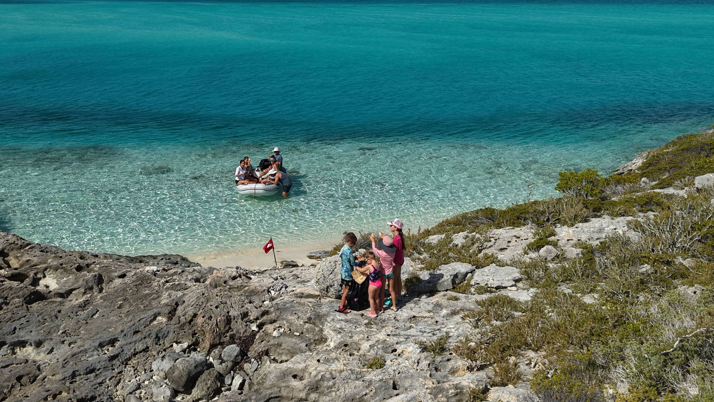 Kids starting a treasure hunt on a family yacht charter in the Exumas, Bahamas