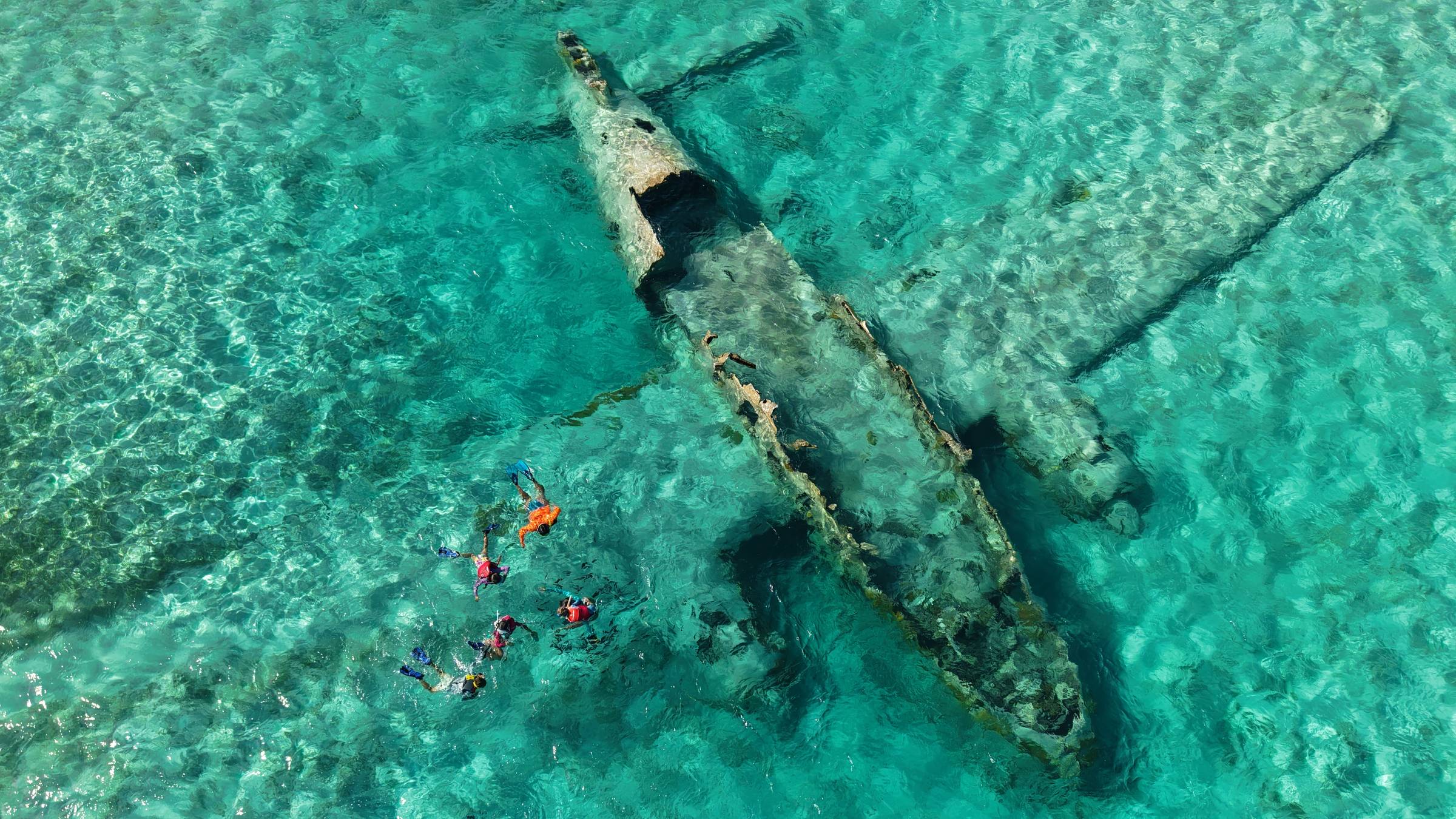 Snorkeling the calm waters surrounding Pablo Escobar's plane in the Exumas, Bahamas